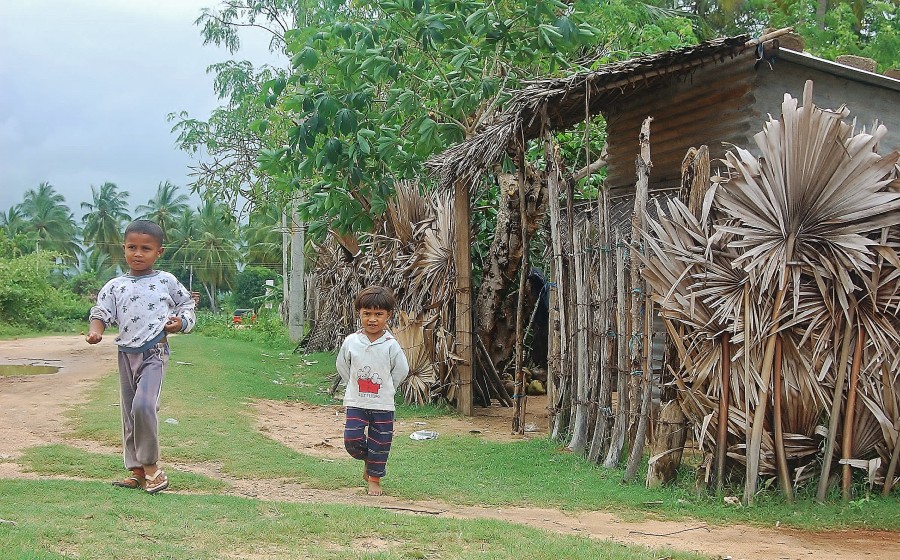 Children from the Trincomalee area coming out of their hut.