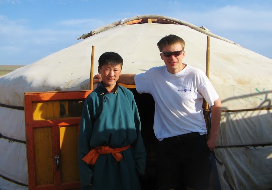 In front of a Mongolian yurt in the Gobi desert, with a Mongolian boy.