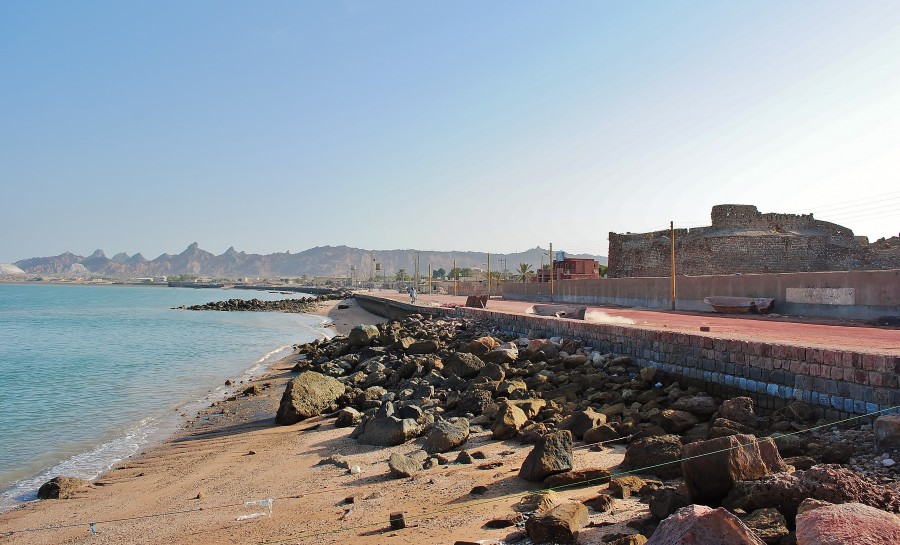 The landscape of of Hormoz island, and the Portuguese castle in the distance. Persian Gulf; Iran.