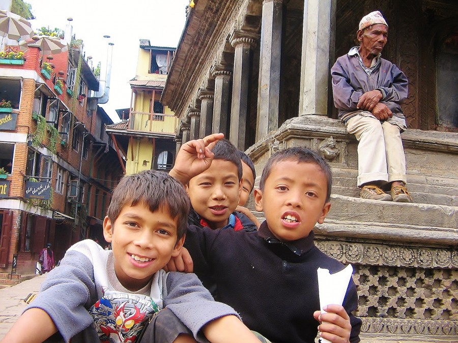 Old and young generation in Nepal. Children are full of energy. The old man has had enough.