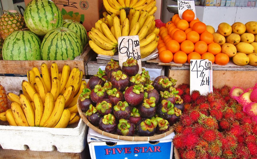 Asian fruit stall. In the photo. Among many: mangosteen, rambutan and mango.